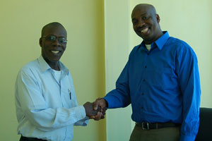 DR MORGAN JOB, shaking hands with SOCA 91.9FM CEO NEIL IWER GEORGE